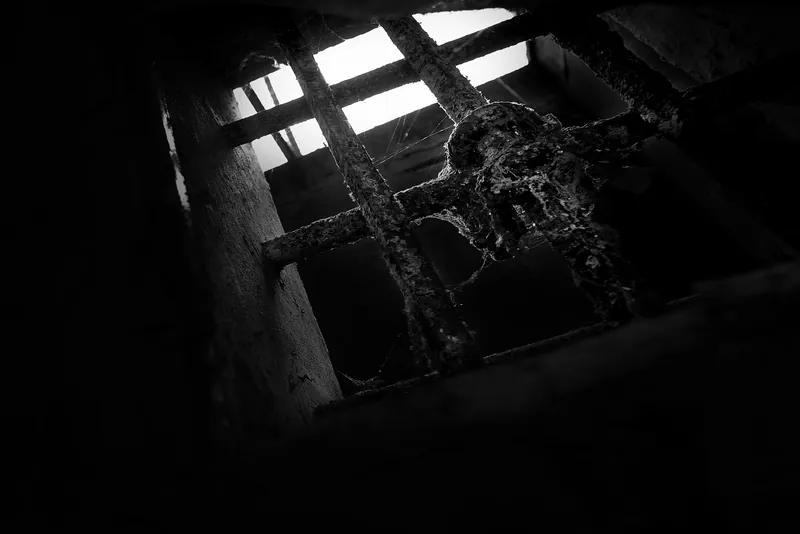 Vergittertes Kellerfenster, von unten gesehen
